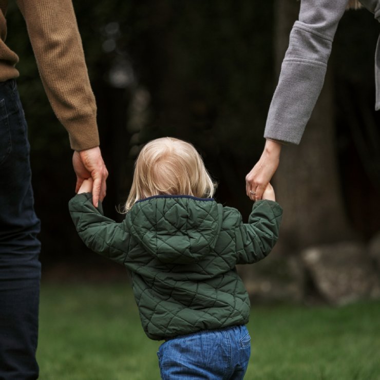 Parents walking with kid in park