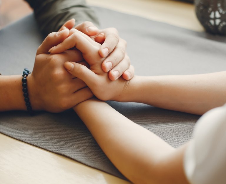 Two people holding hands on a table