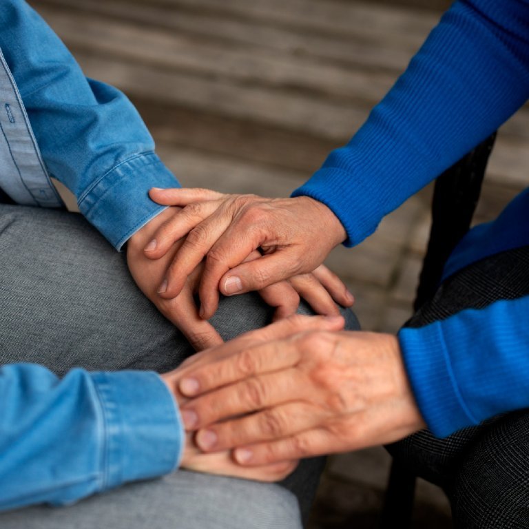 Hands holding each other for support