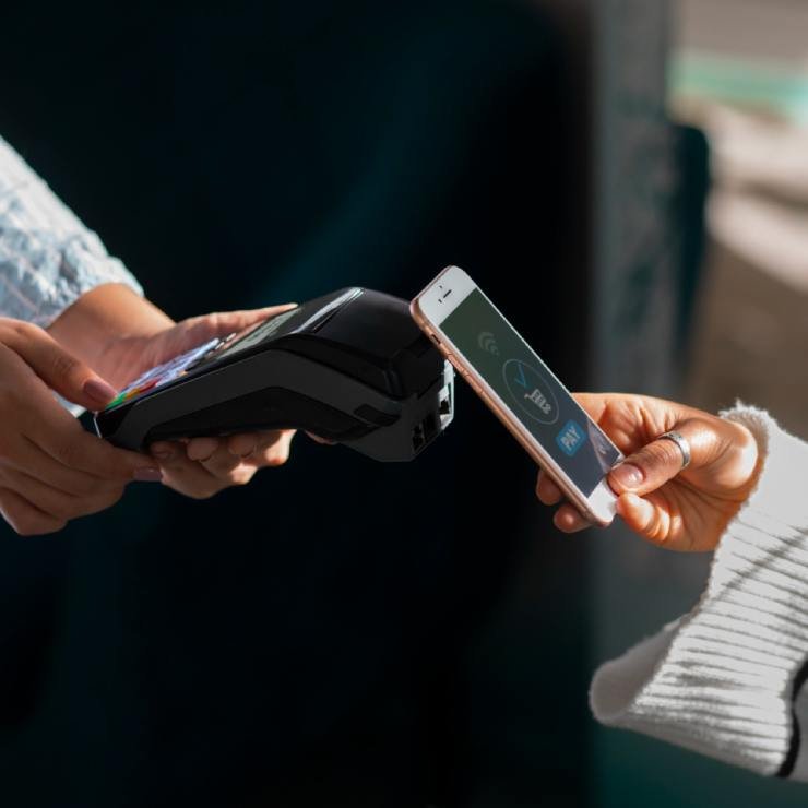 Person paying with nfc technology at a restaurant