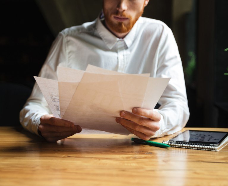 young readhead bearded man working with papers